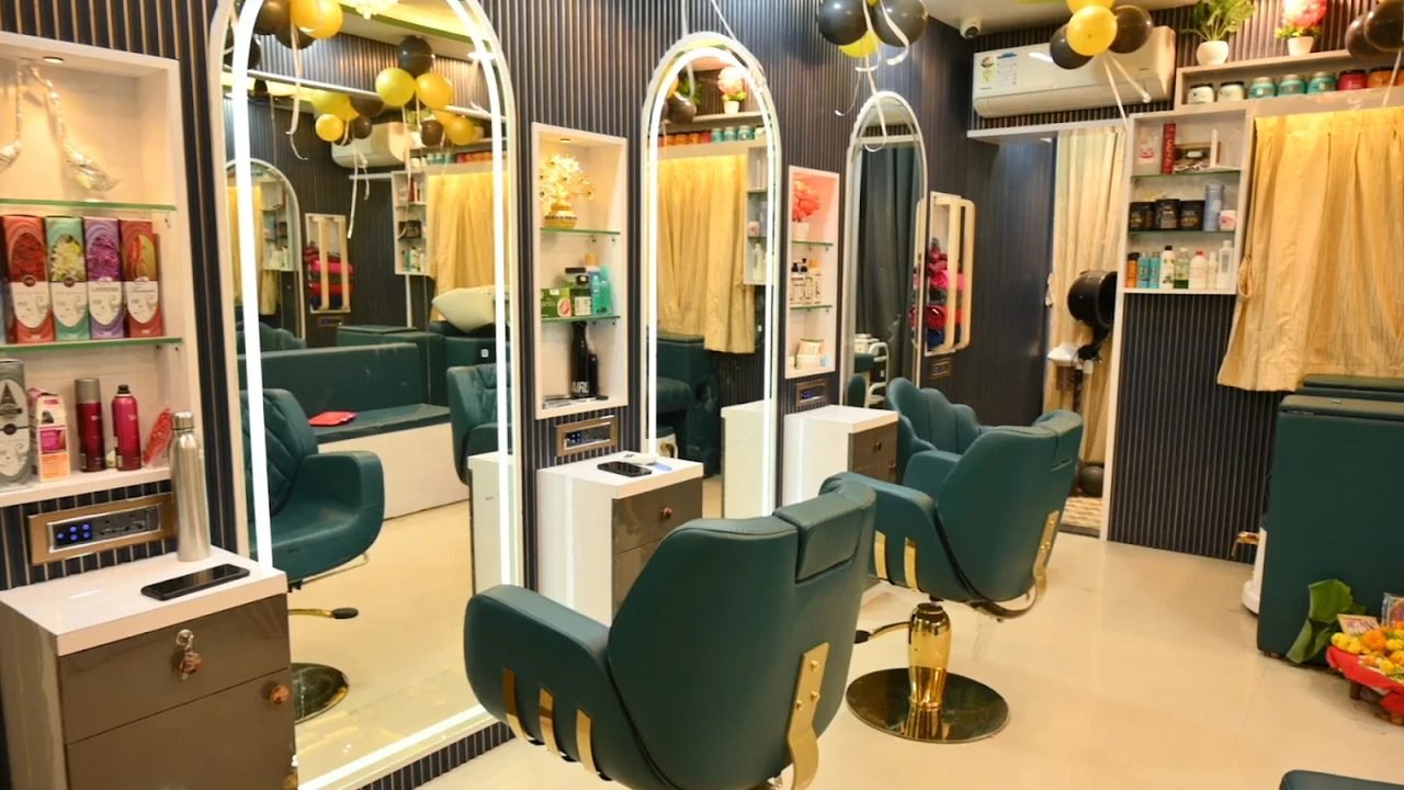 Inside the GlowKaya studio in Manjari Budruk, with teal styling chairs, arched lit mirrors and product shelves